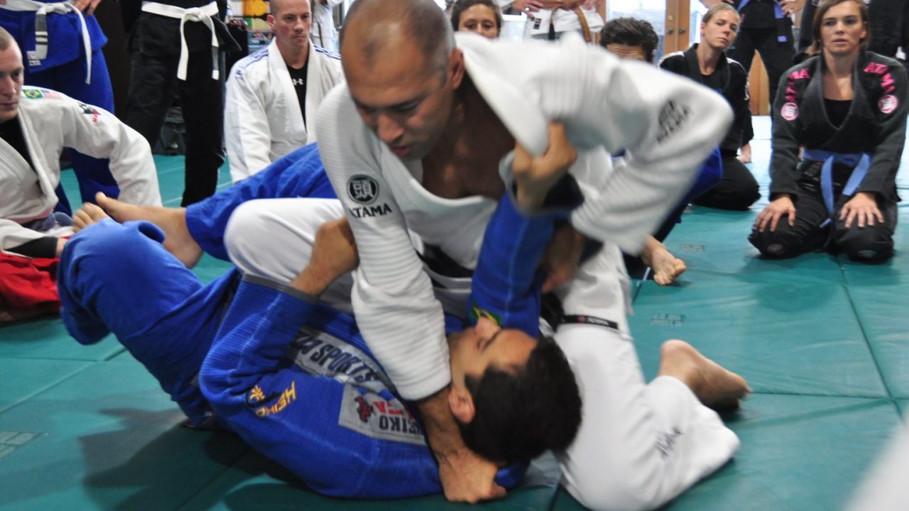 Royce Gracie demonstrating an armbar on a training partner at a jiu-jitsu seminar